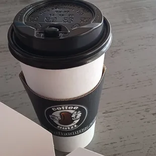 a cup of coffee and a box of donuts