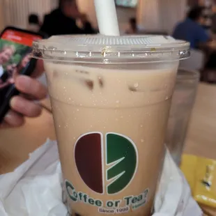 a person taking a picture of a drink