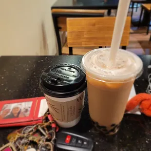 a cup of coffee and a cell phone