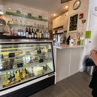 a woman standing in front of a display case
