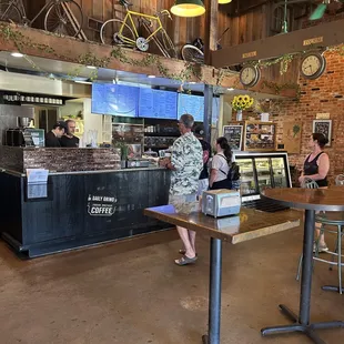 people sitting at tables in a coffee shop