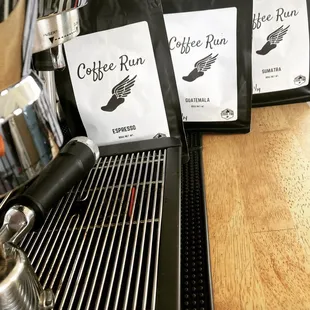 three bags of coffee on a conveyor belt