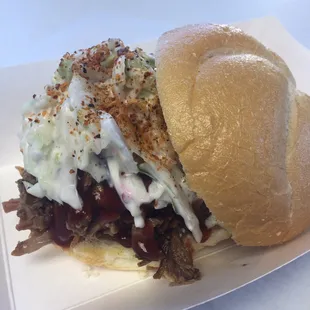 Hickory Smoked Brisket Sandwich on a fresh baked Wimberger&apos;s Bakery Kaiser Roll topped with fresh coleslaw and brown sugar bourbon goodness!