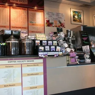 a coffee shop with a menu on the wall