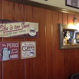 a wooden paneled wall with signs on it