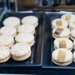 two trays of macarons on display