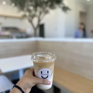 a hand holding a cup of coffee