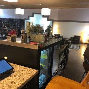 a coffee shop with a laptop on the counter