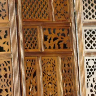 a close up of a wall of carved wood