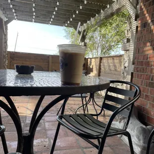 Iced Caramel Macchiato while sitting outside on the covered patio