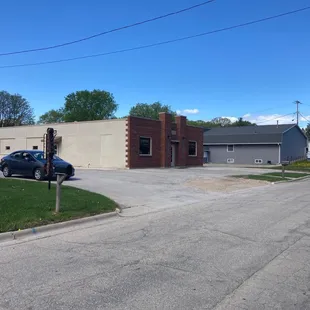 Driveway, road sign, building frontage.