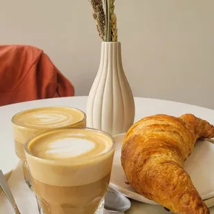 a croissant and a cup of coffee