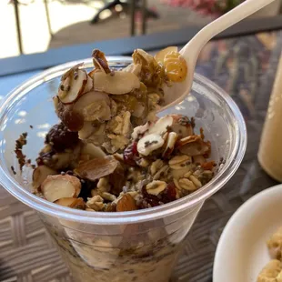 a plastic cup filled with granola and nuts