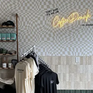 a display of clothing and a neon sign