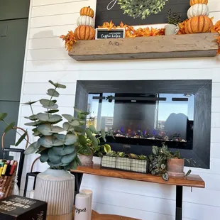 a coffeehouse decorated with pumpkins and greenery