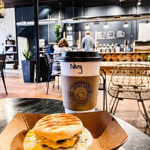 a sandwich and a cup of coffee