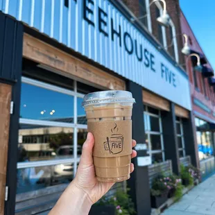 a hand holding a cup of coffee