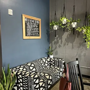 Sign explaining their *for benefit* coffeehouse model.  Cool lounging area, love the hanging plants