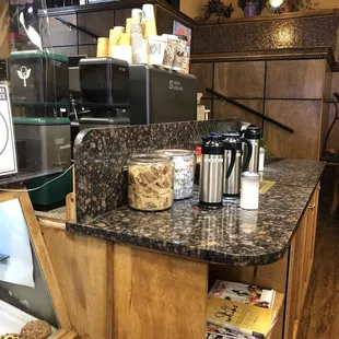 a coffee shop with a counter and shelves