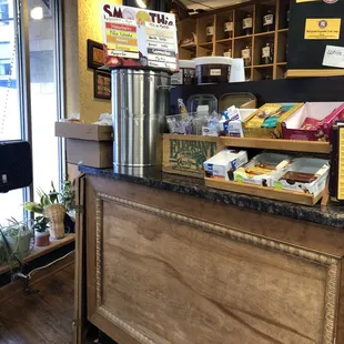 a coffee shop counter with a variety of items