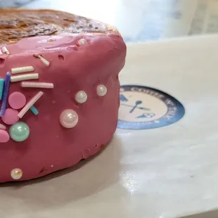 a pink donut with sprinkles