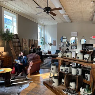 a woman sitting on a couch in a coffee shop