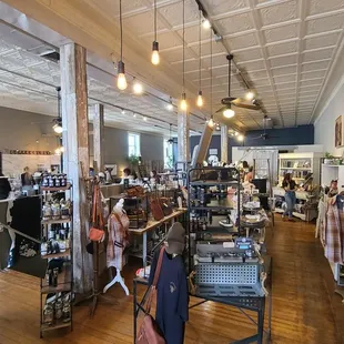 Boutique area + coffee counter. You can see the stairs to go downstairs to the bathroom in between the two. (photo center left)