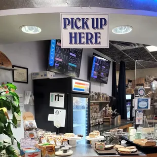 a coffee shop with a sign that says pick up here