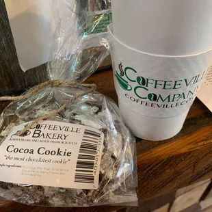 a bag of cocoa cookies and a cup of coffee