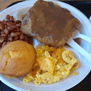 County fried steak over mashed potatoes with gravy, pinto beans, mac &amp; cheese, and corn bread muffin.