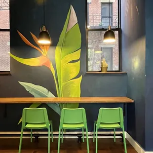 a table with four green chairs