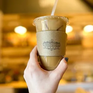 a hand holding a cup of coffee