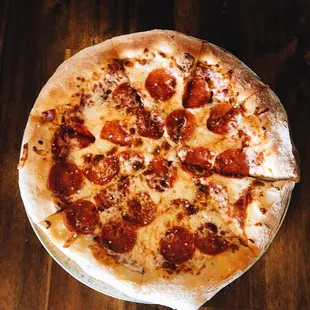 a pepperoni pizza on a table