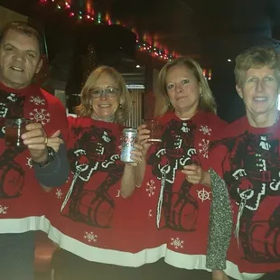 a group of people wearing ugly christmas sweaters