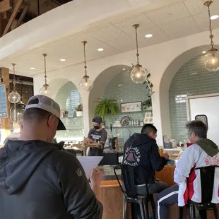 a group of people sitting at a bar