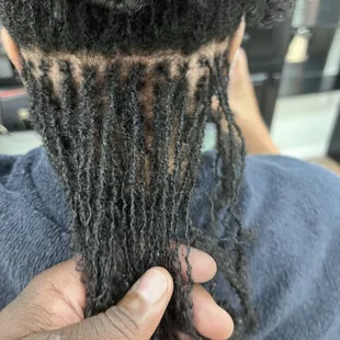 SERVICE: SISTERLOCK RETIGHTENING. I AM HOLDING THE TIGHTENED SECTION.