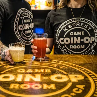 two people holding beer glasses