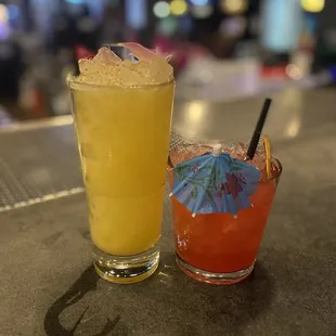two cocktails on a bar