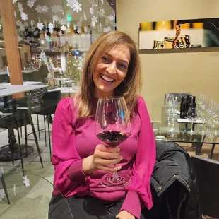 a woman holding a glass of wine
