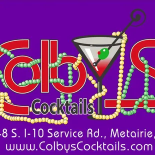 a cocktail glass with beads and a martini