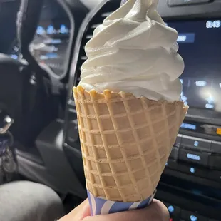 a hand holding an ice cream cone