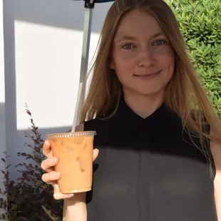a woman holding a cold mountain coffee