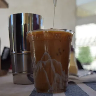 a person pouring coffee into a cup