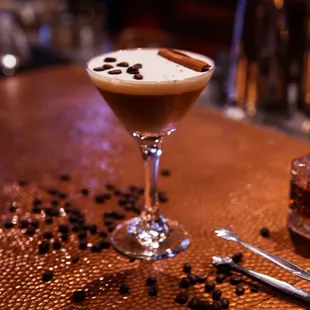 a glass of coffee on a table