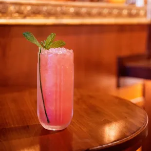a pink drink on a wooden table