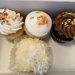 four cupcakes in a box
