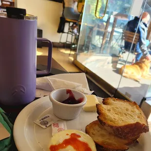 Matcha latte in my own drink container (left) and order of single poached egg and toast. Toast comes with strawberry jam and butter.