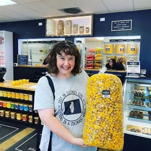 a woman holding a bag of popcorn