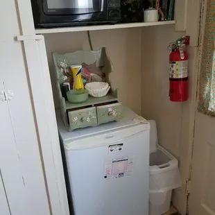 Just what you need to get by! There's also a cupboard full of dishes, cups, and silverware.