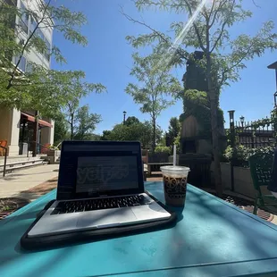 a laptop on a table outside